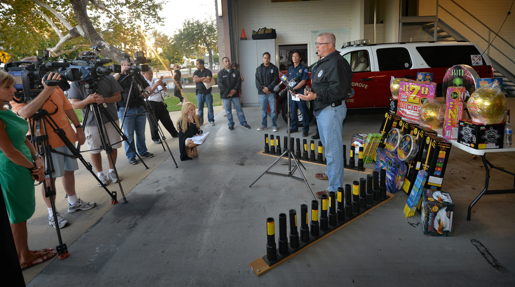 Garden Grove Police Sgt. Carl Whitney answers questions during a news conference at Garden Grove Fire Department Station 1 Wednesday evening after a sting operation yielded the arrest of a 29-year-old man and a cache of more than 1,000 pounds of illegal fireworks with a street value of close to $10,000. Pictured here are just some of the illegal fireworks. Photo by Steven Georges/Behind the Badge OC
