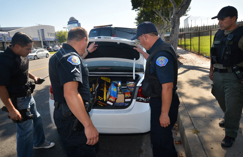 Garden Grove PD open the trunk of a car driven by 29-year-old Jonathan Salgado of Garden Grove to find stacks of illegal fireworks. Photo by Steven Georges/Behind the Badge OC
