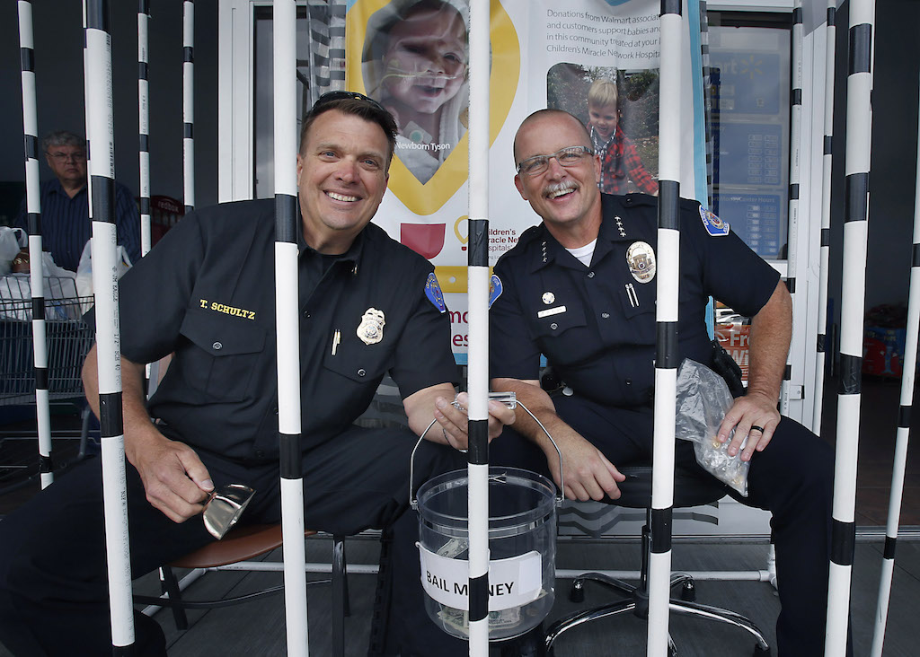 Garden Grove Fire Chief Tom Schultz, left, and Garden Grove Police Chief Todd Elgin pose for a photo in their homemade jail where they were collecting donations in support of a fundraiser for CHOC Children's in Orange on June 5 at a Walmart store in Garden Grove. Walmart had a target of raising $22,000 with the proceeds directly going to CHOC. Photo by Christine Cotter/Behind the Badge OC