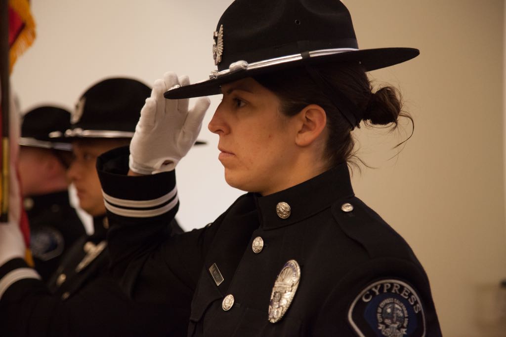 Cypress Officer and Honor Guard member Becky Mathias salutes during the National Anthem. Photo courtesy Cypress PD. 