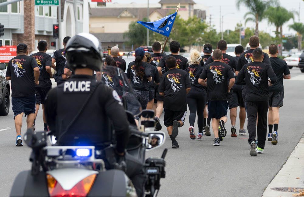 Westminster Police carry the Flame of Hope through the city on the Southern California leg of the law enforcement torch run for the Special Olympics. Photo by Jim Banks/Behind the Badge OC. 