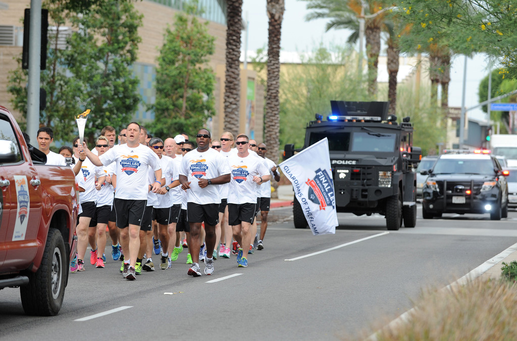Members of law enforcement and Special Olympics athletes take part in the final leg of the Special Olympics torch run in front of Fullerton Police Department headquarters in Fullerton, Calif., on Monday, July 20, 2015. Photo by Carlos Delgado / Behind the Badge OC