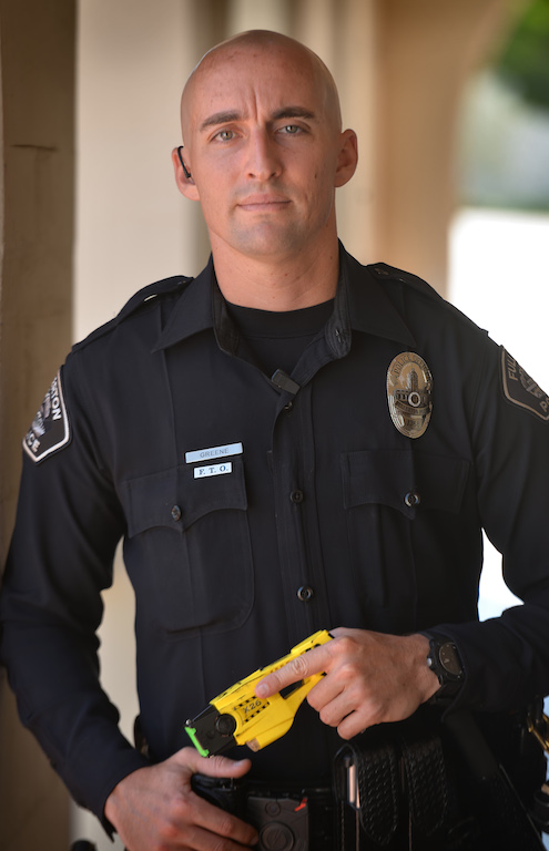 Fullerton PD Officer Mike Greene with the TASER he was able to use instead of a gun on a suicidal man with a knife. Greene is receiving a commendation for his restraint and his quick thinking that helped save the man’s life. Photo by Steven Georges/Behind the Badge OC