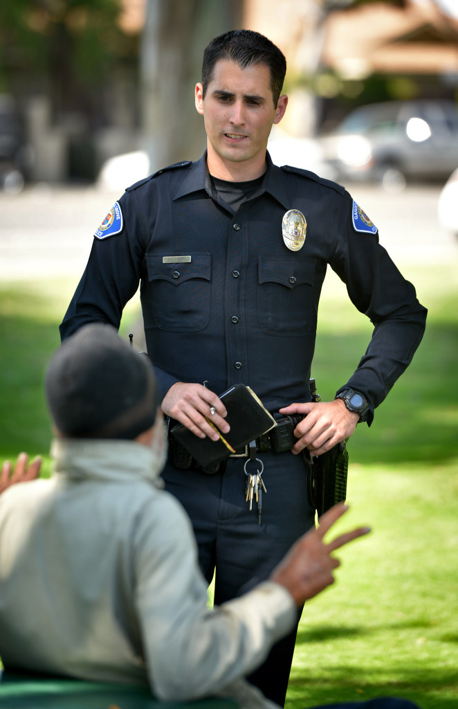 Austin Laverty of the Garden Grove PD talks to a homeless man at Pioneer Park in Garden Grove while on patrol. Photo by Steven Georges/Behind the Badge OC