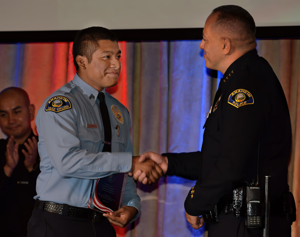 Anaheim PD Explorer Sgt. Teodoro Carachure, left, receives the Golden Explorer Award from Police Chief Raul Quezada during the 2015 Orange County Law Enforcement Explorer Advisors Association Gold Awards Dinner. Photo by Steven Georges/Behind the Badge OC