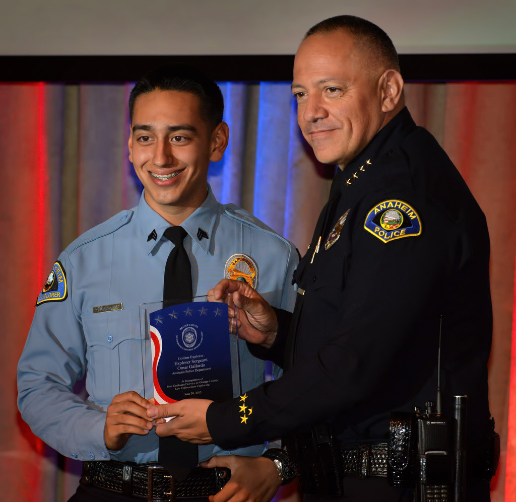 Anaheim PD Explorer Sgt. Omar Gallardo, left, receives the Golden Explorer Award from Police Chief Raul Quezada during the 2015 Orange County Law Enforcement Explorer Advisors Association Gold Awards Dinner. Photo by Steven Georges/Behind the Badge OC