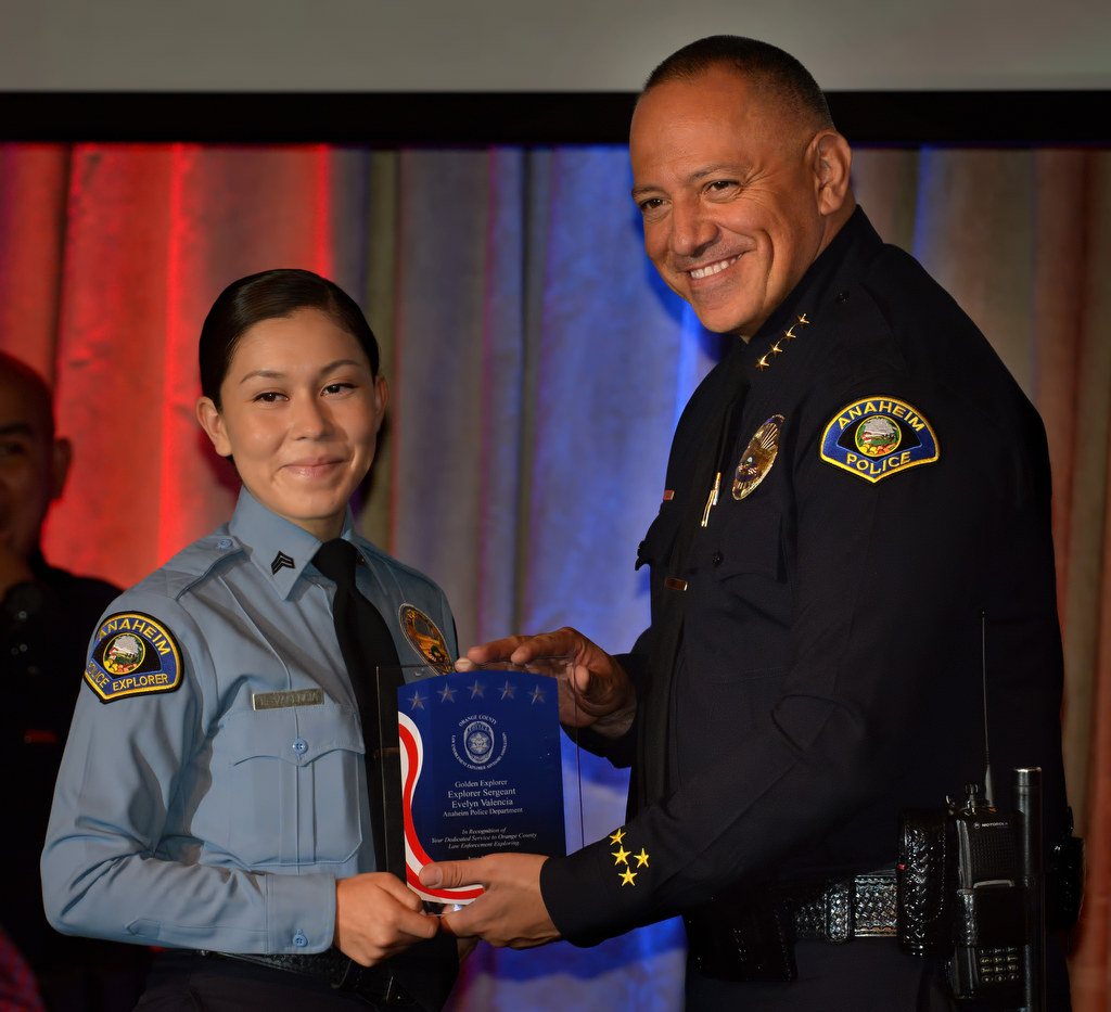 Anaheim PD Explorer Sgt. Evelyn Valencia, left, receives the Golden Explorer Award from Police Chief Raul Quezada during the 2015 Orange County Law Enforcement Explorer Advisors Association Gold Awards Dinner. Photo by Steven Georges/Behind the Badge OC