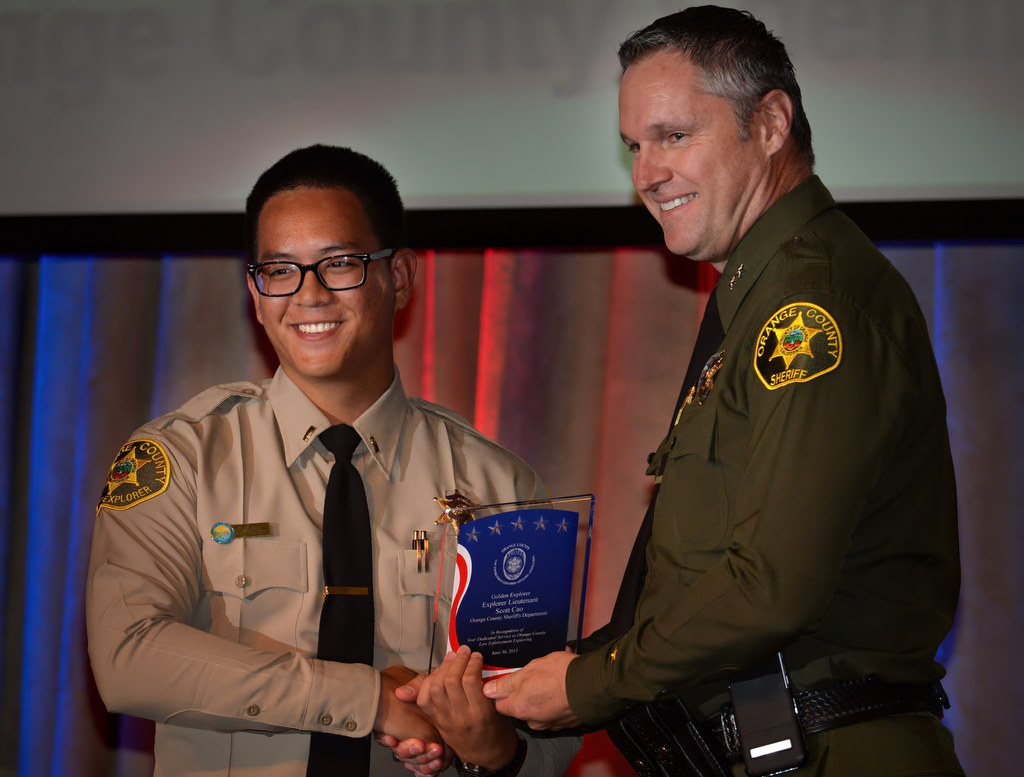 Orange County Sheriff’s Department Explorer Lieutenant Scott Cao, left, receives the Golden Explorer Award from Don Barnes of the OCSD during the 2015 Orange County Law Enforcement Explorer Advisors Association Gold Awards Dinner. Photo by Steven Georges/Behind the Badge OC