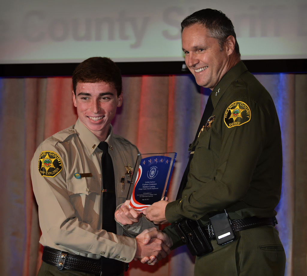 Orange County Sheriff’s Department Explorer Lieutenant Matthew Leading, left, receives the Golden Explorer Award from Don Barnes of the OCSD during the 2015 Orange County Law Enforcement Explorer Advisors Association Gold Awards Dinner. Photo by Steven Georges/Behind the Badge OC