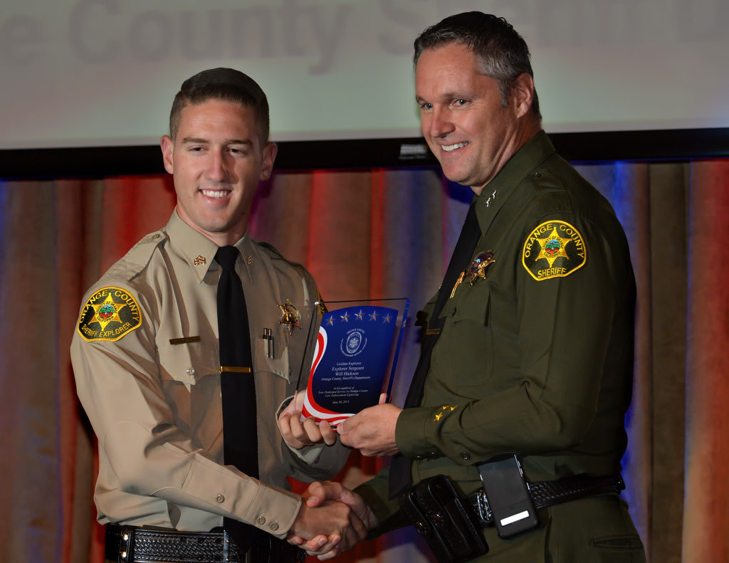 Orange County Sheriff’s Department Explorer Sgt. Will Hickson, left, receives the Golden Explorer Award from Don Barnes of the OCSD during the 2015 Orange County Law Enforcement Explorer Advisors Association Gold Awards Dinner. Photo by Steven Georges/Behind the Badge OC