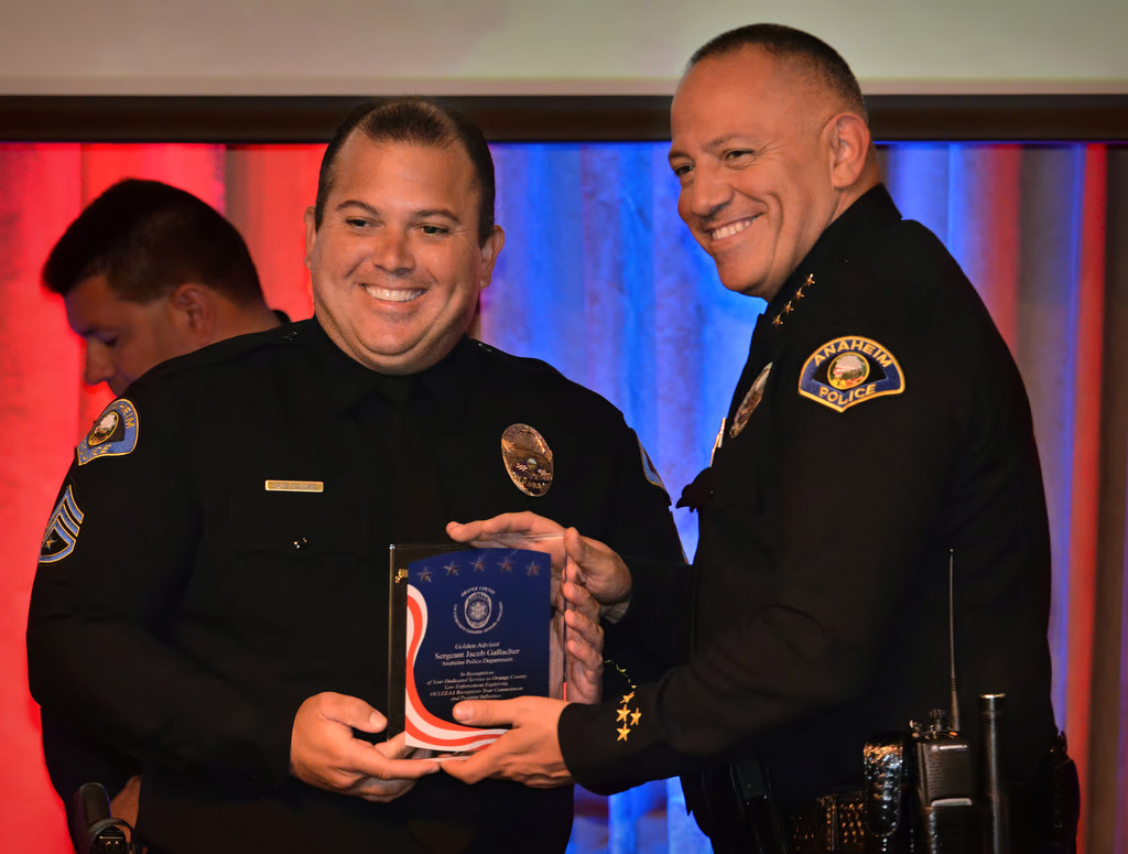 Sergeant Jacob Gallacher of the Anaheim PD, left, receives the Golden Advisor Award from Anaheim Police Chief Raul Quezada during the 2015 Orange County Law Enforcement Explorer Advisors Association Gold Awards Dinner. Photo by Steven Georges/Behind the Badge OC