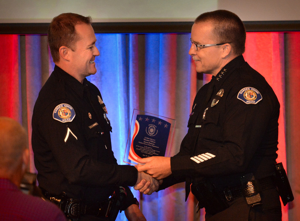 Master Officer Jason Perkins of the Garden Grove PD, left, receives the Golden Advisor Award from Police Chief Todd Elgin during the 2015 Orange County Law Enforcement Explorer Advisors Association Gold Awards Dinner. Photo by Steven Georges/Behind the Badge OC