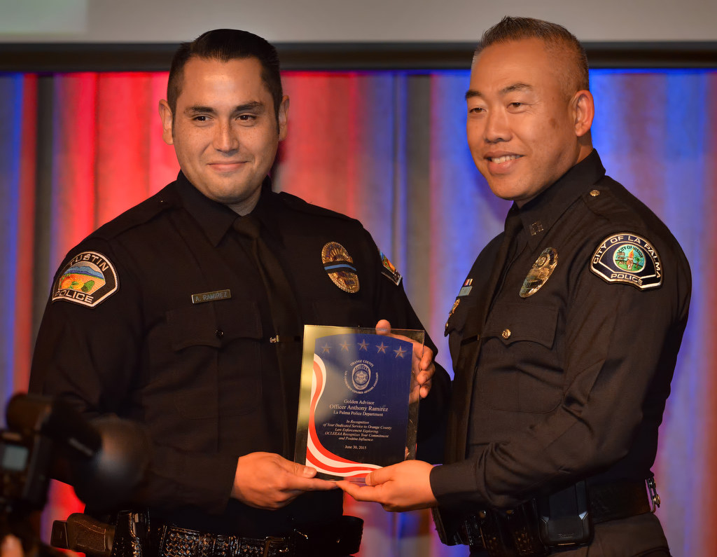 Officer Anthony Ramirez of the La Palma PD, right, receives the Golden Advisor Award from Tustin PD Officer Ramirez during the 2015 Orange County Law Enforcement Explorer Advisors Association Gold Awards Dinner. Photo by Steven Georges/Behind the Badge OC