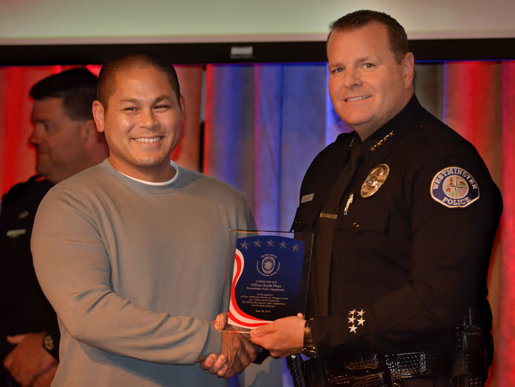 Officer Keith Phan of the Westminster PD, right, receives the Golden Advisor Award from Westminster Police Chief Kevin Baker during the 2015 Orange County Law Enforcement Explorer Advisors Association Gold Awards Dinner. Photo by Steven Georges/Behind the Badge OC