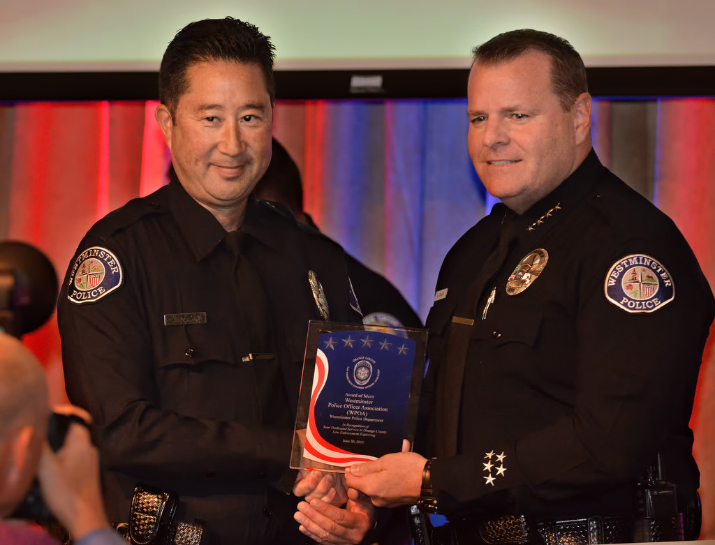 The Westminster Police Officer Association (WPOA) receives an Award of Merit handed to them by Westminster Police Chief Kevin Baker during the 2015 Orange County Law Enforcement Explorer Advisors Association Gold Awards Dinner. Photo by Steven Georges/Behind the Badge OC