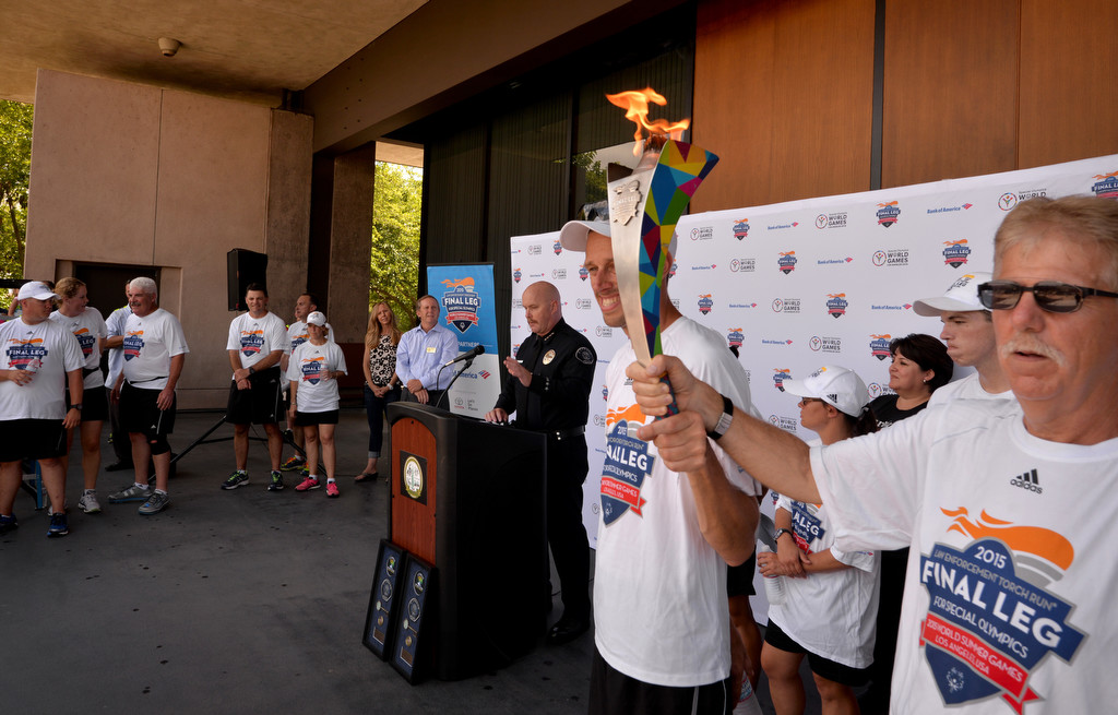 Cypress Interim Chief of Police Rod Cox welcomes the runners from the Law Enforcement Torch Run Final Leg for Special Olympics after arriving at the Cypress Civic Center. Photo by Steven Georges/Behind the Badge OC