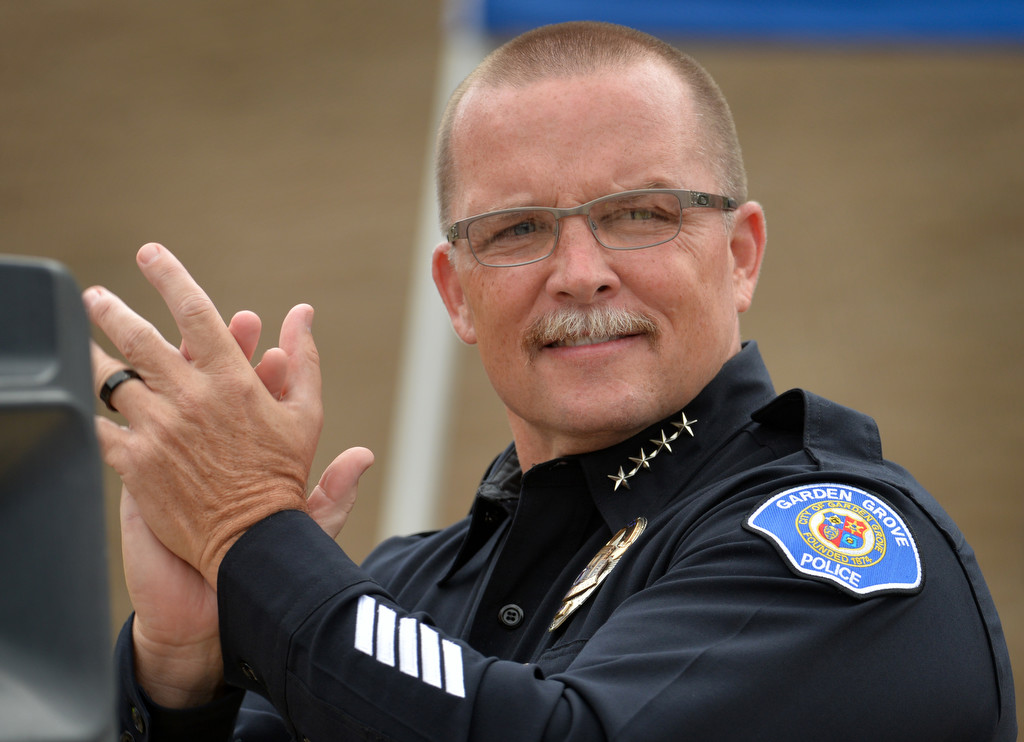 Garden Grove Police Chief Todd Elgin applauds the athletes during a ceremony at the Garden Grove PD to welcome the Special Olympics torch. Photo by Steven Georges/Behind the Badge OC