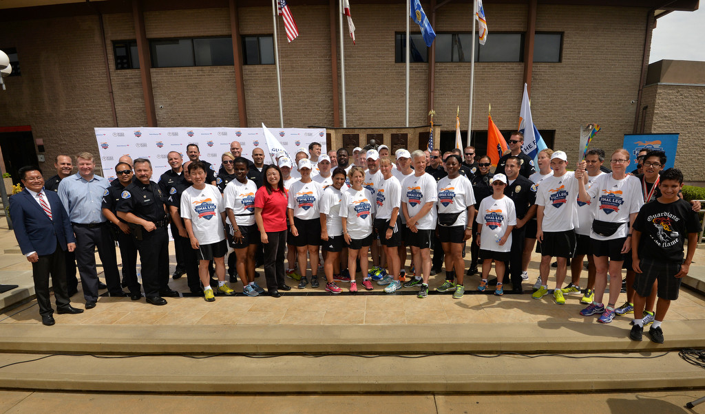 The Special Olympics Law Enforcement Torch Run Final Leg crew join Garden Grove Mayor Bao Nguyen, left, Mayor Pro Tem Steve Jones Police Chief Todd Elgin and California State Senator Janet Nguyen (red shirt) gather for a group photo as the Special Olympics torch makes a stop at the Garden Grove PD headquarters. Photo by Steven Georges/Behind the Badge OC