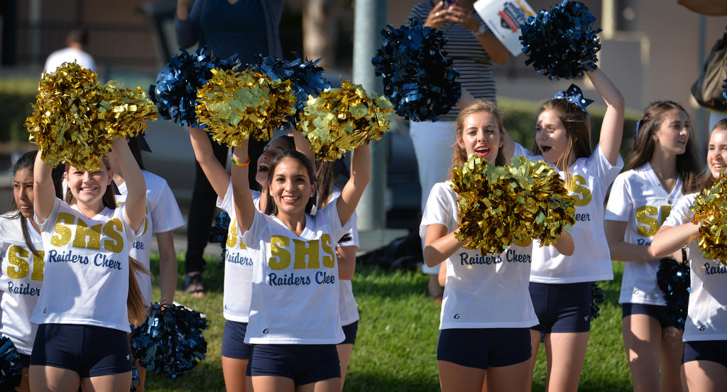 Girls from the Sonora High School Cheer team cheer on the Law Enforcement Torch Run Final Leg runners for Special Olympics as they arrive at the La Habra Community Center for a ceremony hosted by the La Habra PD. Photo by Steven Georges/Behind the Badge OC