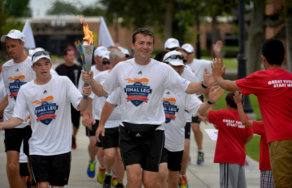 Runners from the Law Enforcement Torch Run Final Leg for Special Olympics arrive the Westminster Police Department. Photo by Steven Georges/Behind the Badge OC