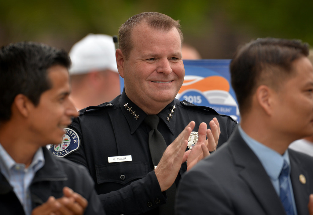 Westminster Police Chief Kevin Baker welcomes the Special Olympics torch during a ceremony at the Westminster PD. Photo by Steven Georges/Behind the Badge OC