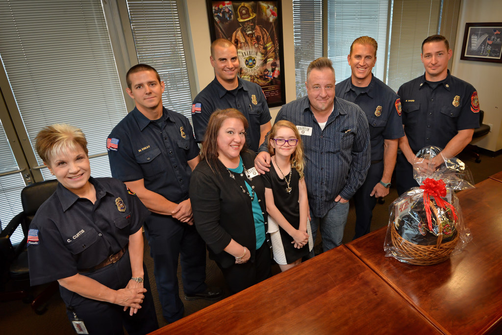 Twelve-year-old Angela Chute with with her mother Bernadette Chute, father William Chute, and the Anaheim Fire & Rescue team that responded when Angela called 911 after her father had a seizure. Photo by Steven Georges/Behind the Badge OC