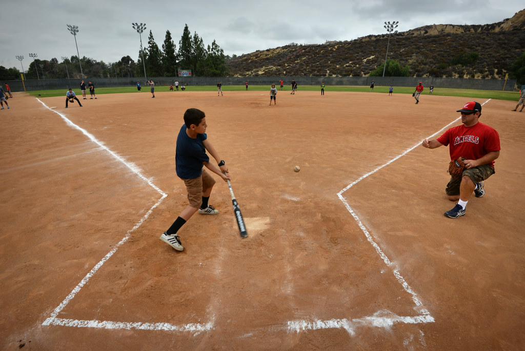 Julian Ramirez, 12, gets his turn at bat during a baseball camp for at-risk kids at "The YardÓ in Fullerton. Photo by Steven Georges/Behind the Badge OC