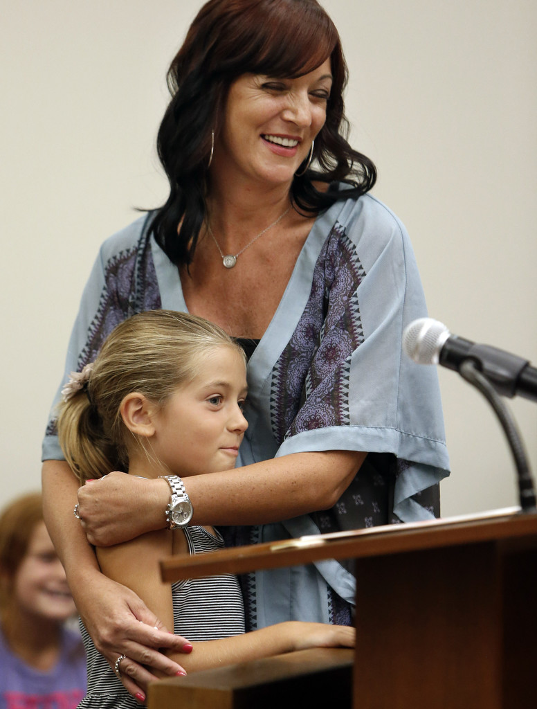 Kelli Capone hugs her daughter Rachel in Harbor Superior Court during her graduation from rehab. Tustin police officers David Welde and John Hedges were instrumental in getting her in the program. Photo by Christine Cotter/Behind the Badge OC