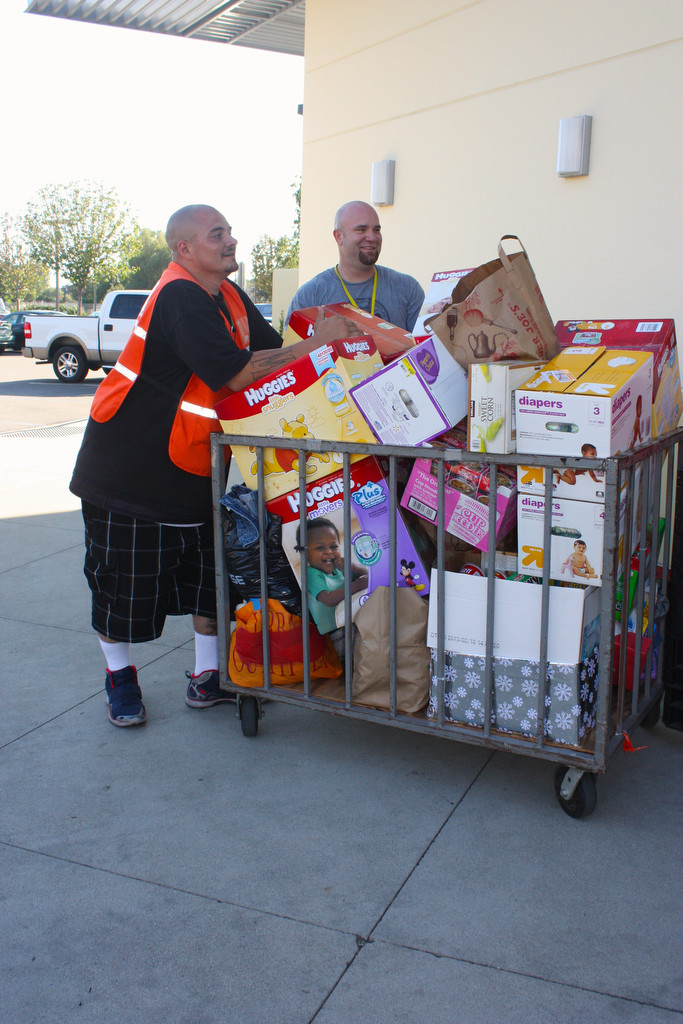 Workers bring donations into the warehouse at Orange County Rescue Mission. Photo: Behind the Badge OC. 