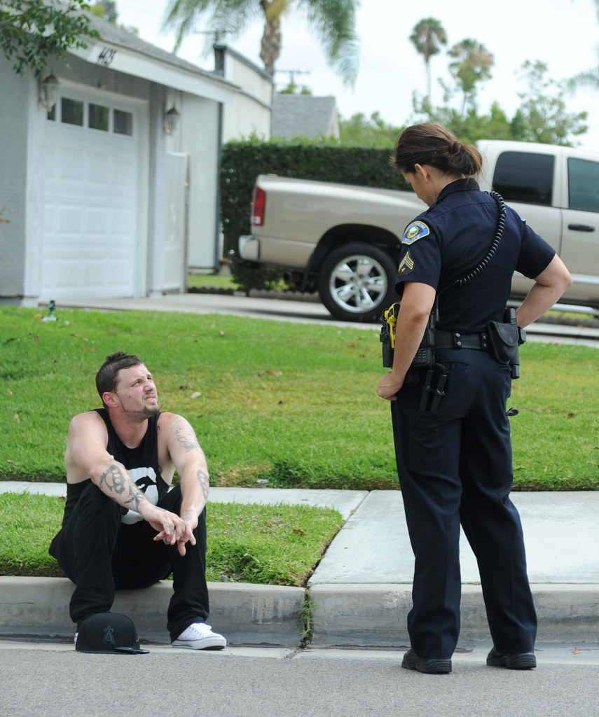 Alisha Halczyn, of the Anaheim Police Department, questions a young male who she stopped for suspicious behavior in Anaheim Hills, Calif., on Monday, July 20, 2015. Photo by Carlos Delgado  /  Behind the Badge OC