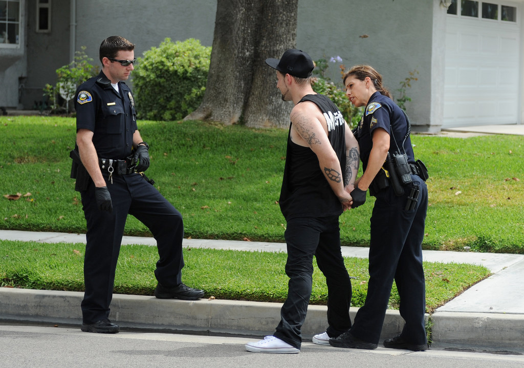 Alisha Halczyn, right, and Daniel Wolfe, of the Anaheim Police Department, question a suspect who was stopped for suspicious behavior in Anaheim Hills, Calif., on Monday, July 20, 2015. Photo by Carlos Delgado  /  Behind the Badge OC