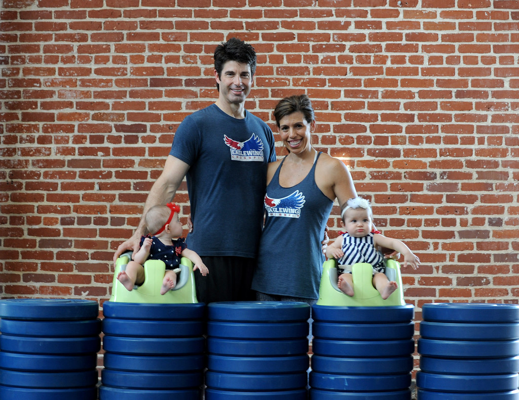 The Halczyn family, clockwise from left, Bill, Alisha, Emmerson, and Zoe are photographed at Eaglewing Crossfit, the gym Bill and Alisha own together, in Anaheim, Calif., on Wednesday, July 29, 2015. Photo by Carlos Delgado  /  Behind the Badge OC