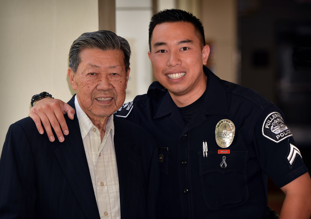 Detective Billy Phu of the Fullerton PD with his grandfather Suu Nguyen. Photo by Steven Georges/Behind the Badge OC