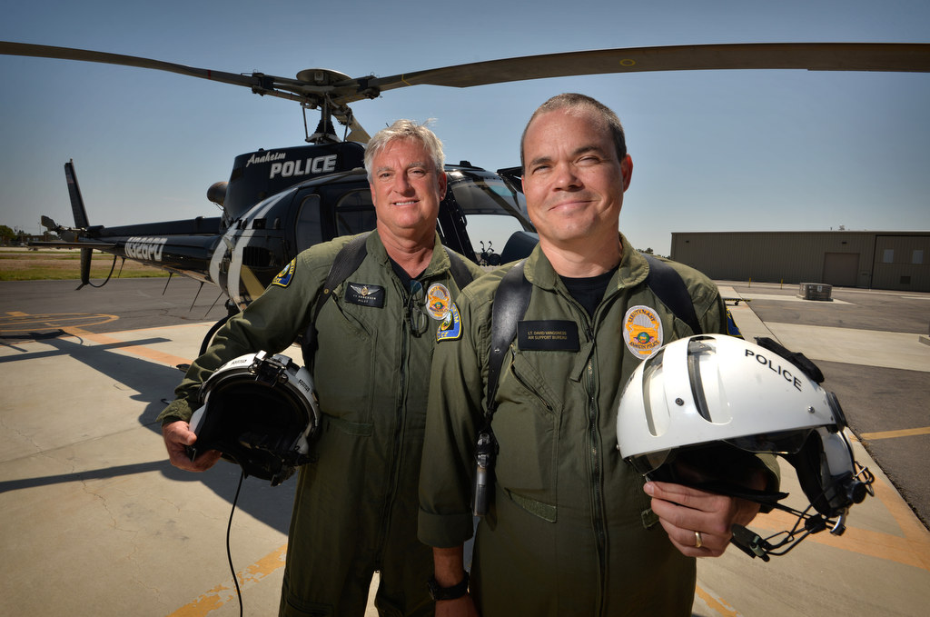 Anaheim PD Officer Ty Hagenson, left, and Lt. David Vangsness, in front of the Anaheim Police helicopter they fly out of Fullerton Airport. Photo by Steven Georges/Behind the Badge OC