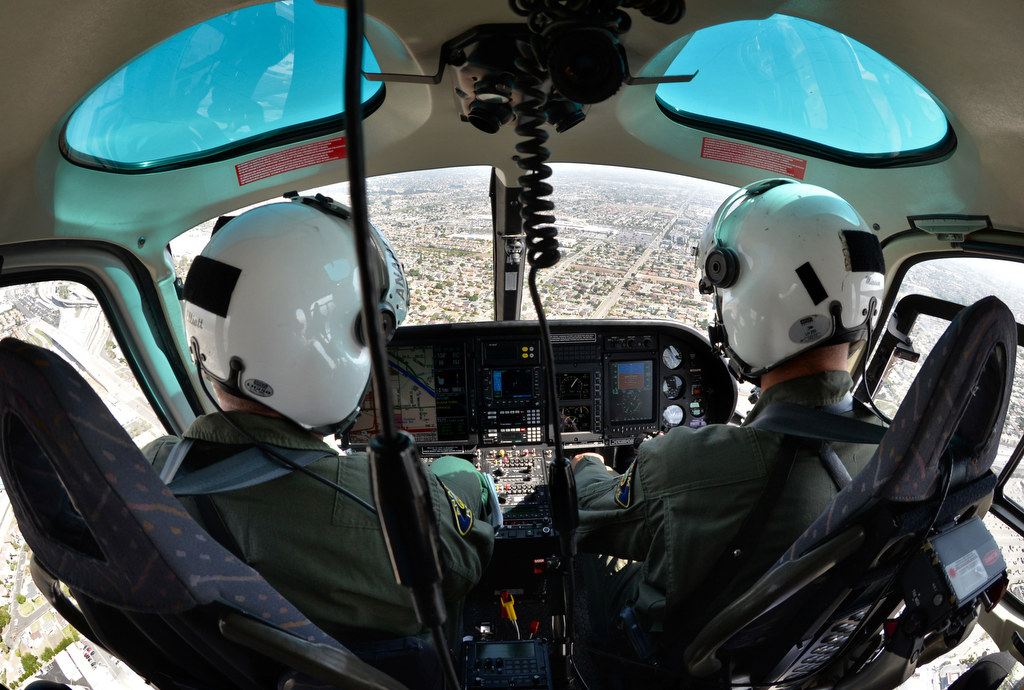 Anaheim PD Officers Jimmy Elliott, left, and Dietrich Miessner fly Anaheim PD’s Angel helicopter over the city of Anaheim. Photo by Steven Georges/Behind the Badge OC