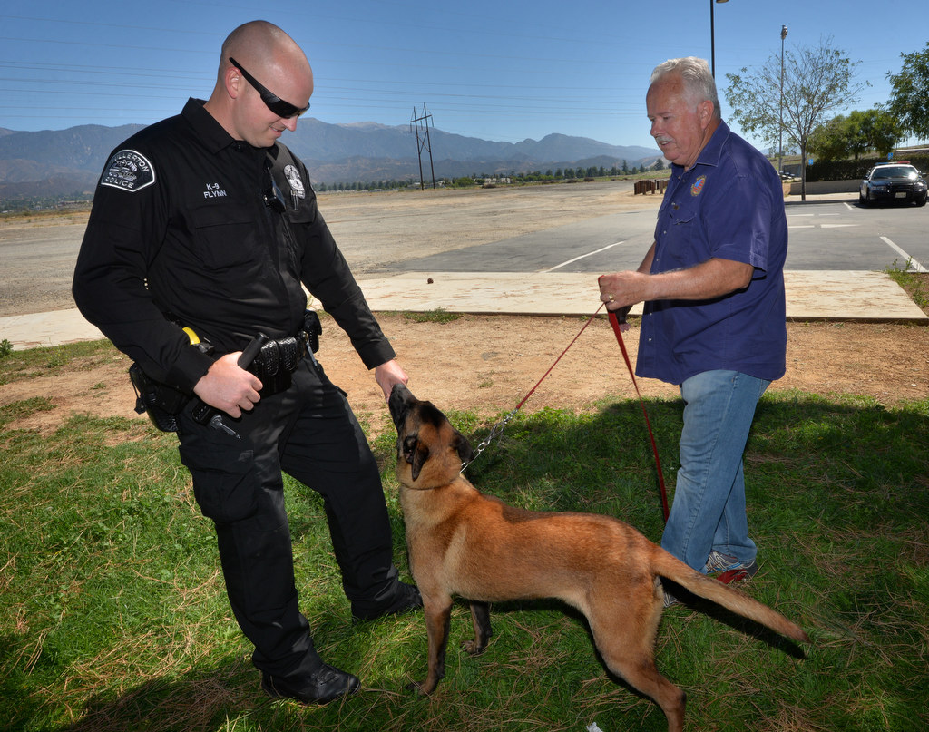 K-9 Instructor Patrick Beltz, right, brings Jobi up to greet Fullerton Police Officer Scott Flynn, who will be xxxÕ new K-9 police partner. Photo by Steven Georges/Behind the Badge OC