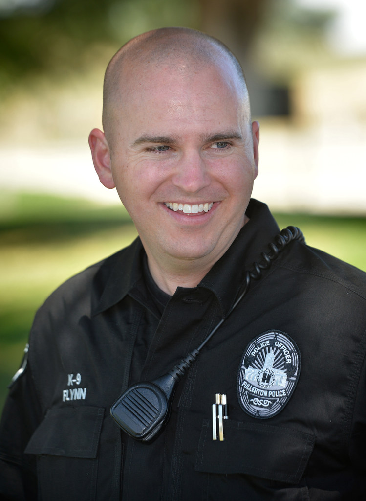 Fullerton Police Officer Scott Flynn smiles after he and his fellow officers decided to take Jobi on his ScottÕs new K-9 partner. Photo by Steven Georges/Behind the Badge OC