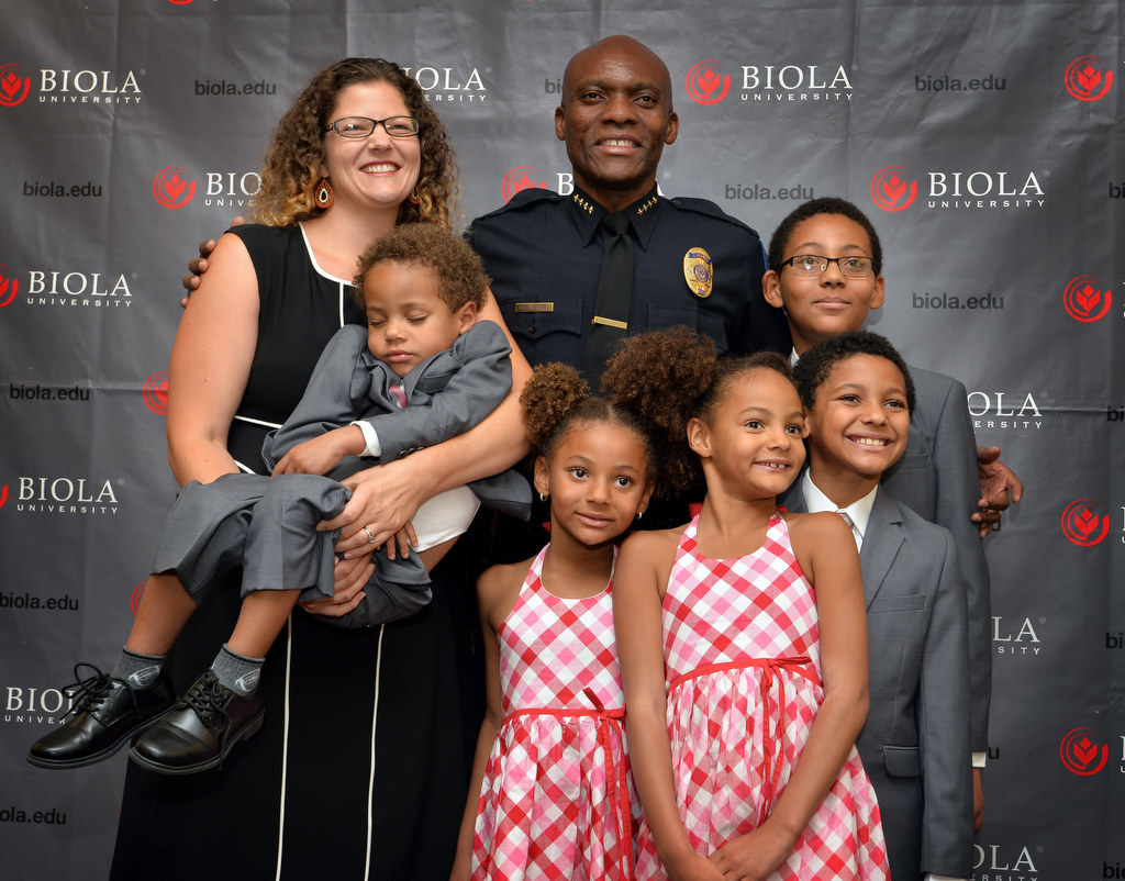 Biola University Chief of Campus Safety and Garden Grove PD Reserve Officer John Ojeisekhoba with his wife Heidi and his five kids from left, James, 3, Nicole, 6, Natalie, 8, John Jr., 11, back row, and Joshua, 10, after a ceremony honoring him for receiving the Director of the Year Campus Safety award. Photo by Steven Georges/Behind the Badge OC