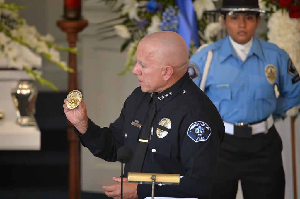 Buena Park Police Chief Corey Sianez holds up Buena Park PD badge #968 that he awarded to Vince Parra, an 18-year-old Buena Park Explorer who passed away from cancer. The Chief Sianez made the presentation during a memorial service for Parra at Forest Lawn Memorial Park in Cypress. Photo by Steven Georges/Behind the Badge OC