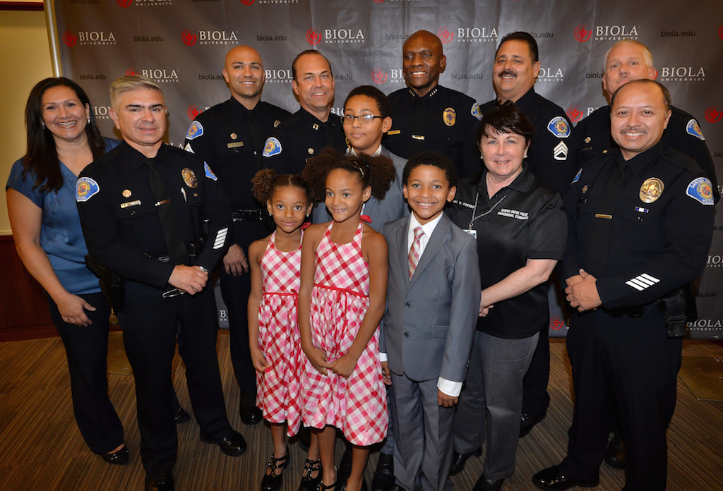 Members of the Garden Grove PD gather with Biola University Chief of Campus Safety and Garden Grove PD Reserve Officer John Ojeisekhoba and some of his family after a ceremony honoring him for receiving the Director of the Year award from Campus Safety Magazine. Photo by Steven Georges/Behind the Badge OC