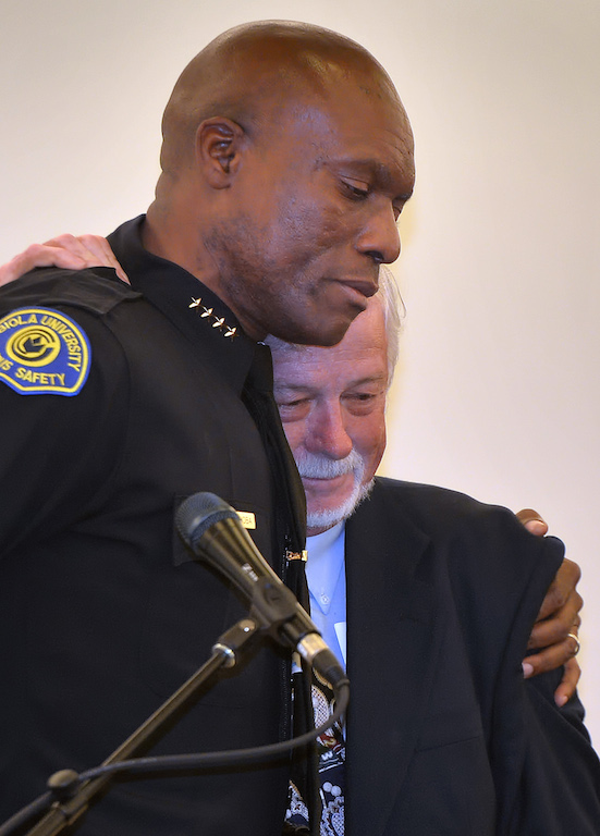 “This is the man who brought me from Africa,”  Biola University Chief of Campus Safety and Garden Grove PD Reserve Officer John Ojeisekhoba, left, says as he gives his friend Leroy Neal a hug during a ceremony honoring Chief Ojeisekhoba at Biola University. Photo by Steven Georges/Behind the Badge OC