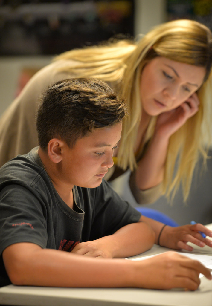 Lily Dueñas, class facilitator, works with Benjamin Torrevillas, 13, during a Marijuana Support Class, part of the Boys & Girls Clubs of Garden Grove’s Family & Youth Outreach Program at the Juvenile Justice Center next to the GGPD. Photo by Steven Georges/Behind the Badge OC