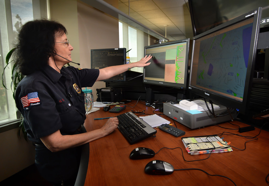 Metro Net Dispatch Supervisor Gloria Re takes some calls at her 911 station. She will be retiring after more that 34 years as a dispatcher, 29 years with MetroNet: Communications & Dispatch in Anaheim. Photo by Steven Georges/Behind the Badge OC