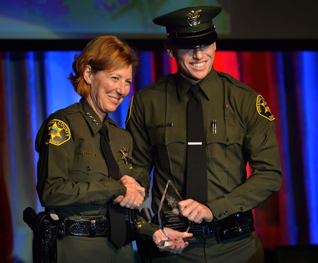 Orange County Sheriff Sandra Hutchens presents Deputy Joshua Wiggs with the Outstanding Firearms Skills award during the OCSRTA class of 216’s graduation ceremony. Photo by Steven Georges/Behind the Badge OC