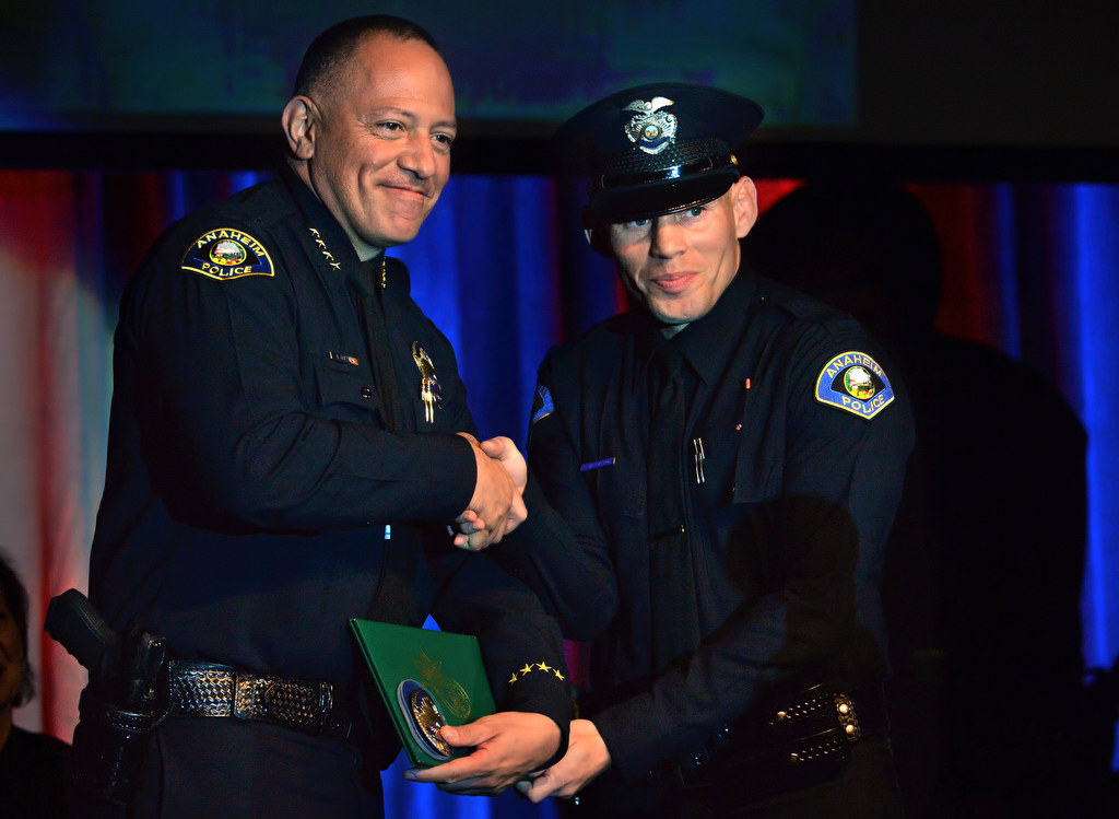 Anaheim Police Chief Raul Quezada presents a badge to Anaheim’s new officer Steve Magdaleno during the OCSRTA class of 216’s graduation ceremony. Photo by Steven Georges/Behind the Badge OC