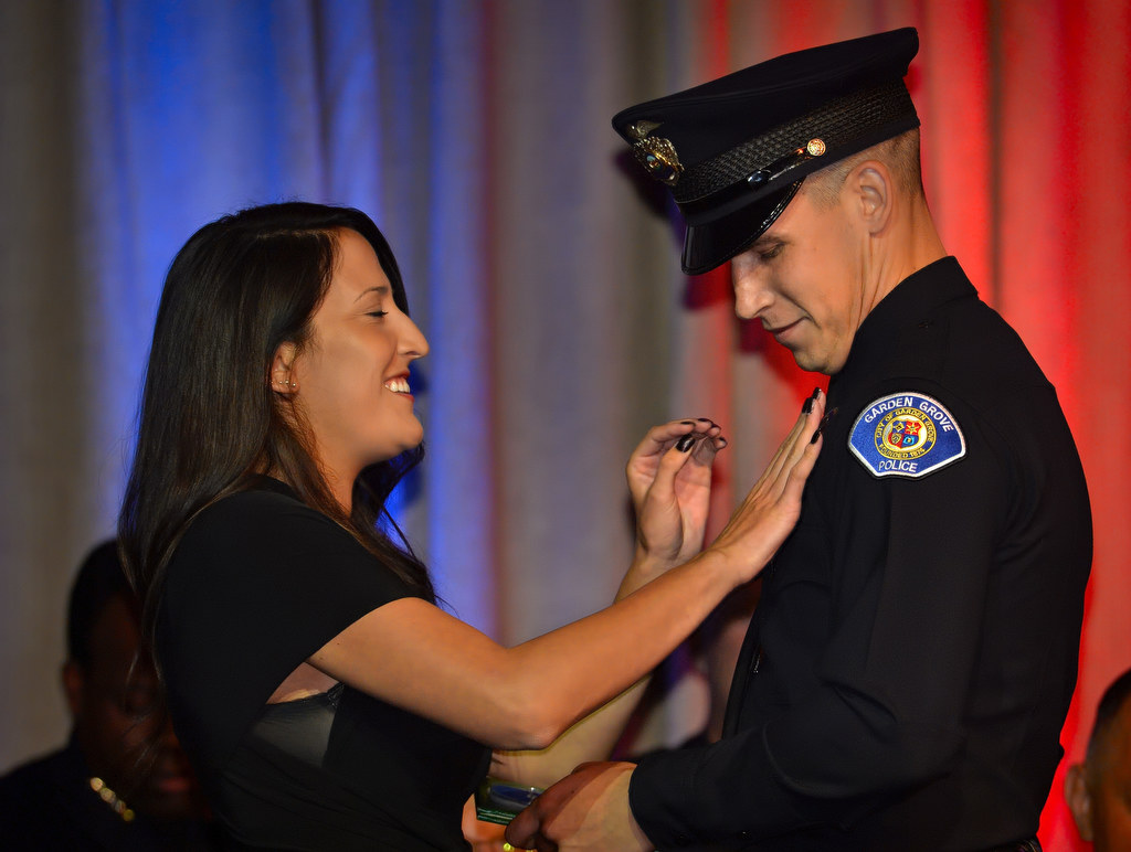 Garden Grove Officer Michael Gerdin gets his new badge pinned to him by his girlfriend Courtney during the OCSRTA class of 216’s graduation ceremony. Photo by Steven Georges/Behind the Badge OC