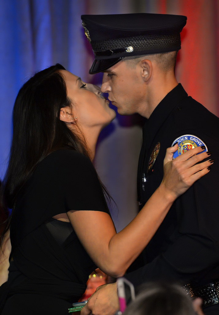 Garden Grove Officer Michael Gerdin gets a kiss from his girlfriend Courtney after receiving his badge during the OCSRTA class of 216’s graduation ceremony. Photo by Steven Georges/Behind the Badge OC