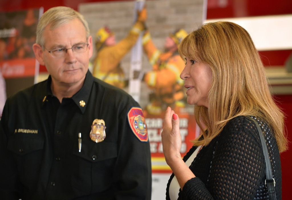 Anaheim Fire & Rescue Chief Randy Bruegman listens during a press conference on the safety of bicycle helmets as Carmen Lofgren tells the story of how her son Gary was 25 when he was injured and later died in a bicycle accident last year.  Photo by Steven Georges/Behind the Badge OC