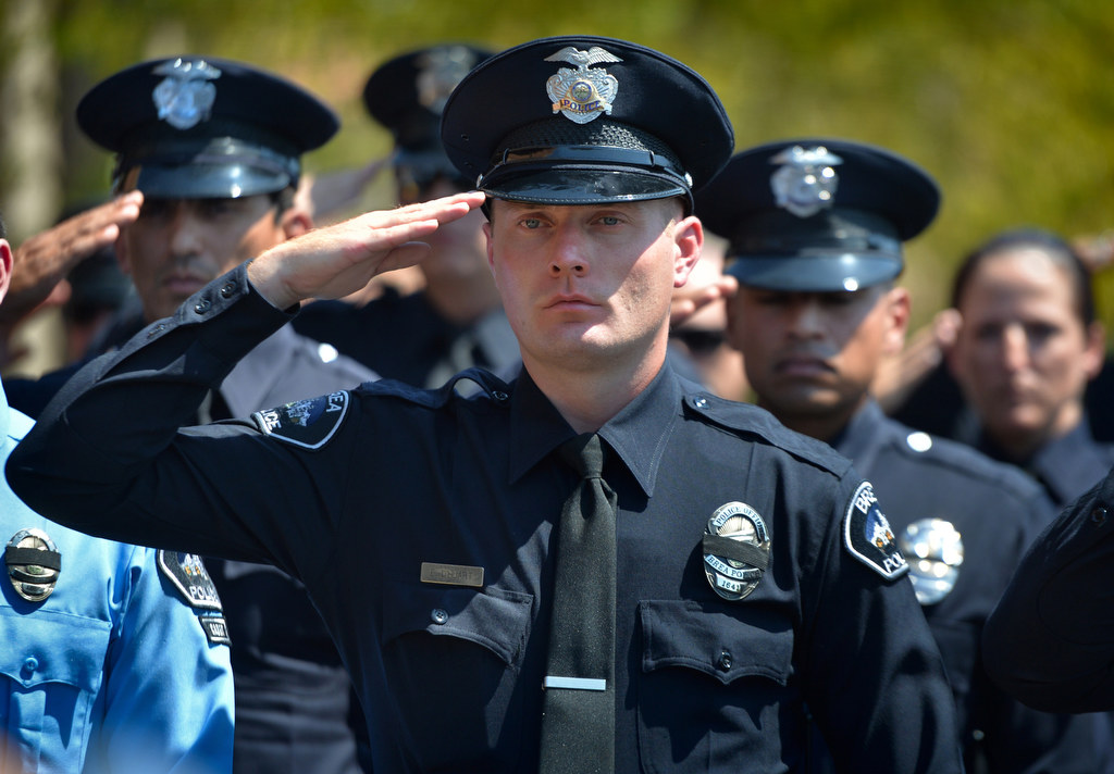 Brea PD Officer Evan d'Huart salutes as the casket of Brea PD Officer Daniel McKinley is carried out at the conclusion of funeral services. Photo by Steven Georges/Behind the Badge OC