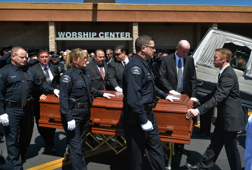 Pallbearers from Brea PD and family carry the casket of Brea PD Officer Daniel McKinley out of Evangelical Free Church at the conclusion of funeral services. Photo by Steven Georges/Behind the Badge OC